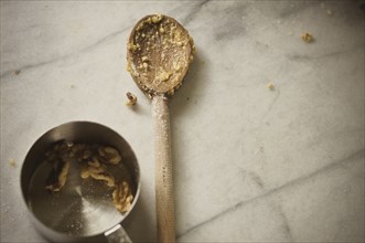 Close up of wooden spoon and measuring cup