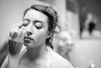 Teenage girl having makeup applied