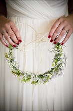 Caucasian bride holding flower headband