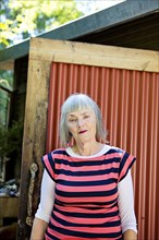 Older Caucasian woman standing in backyard