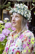Stylish older Caucasian woman wearing floral cap