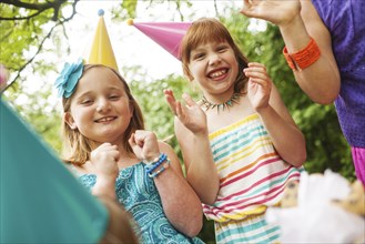Girls clapping at birthday party outdoors