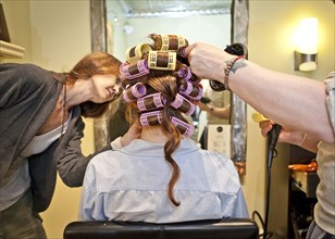 Woman having hair styled in salon