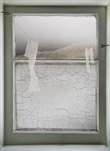 Paper hanging on wire across window