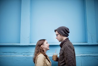 Couple standing near blue wall