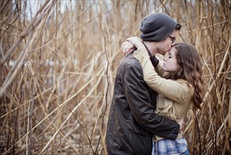 Couple hugging in branches