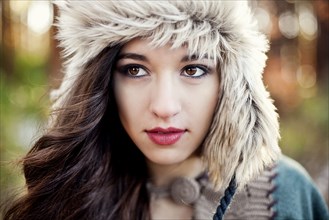 Close up of serious woman wearing furry hat