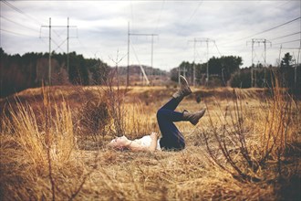 Girl laying on back in field