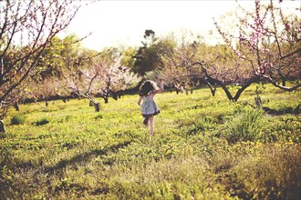 Girl playing in rural field