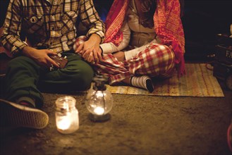 Couple relaxing in camping tent at night