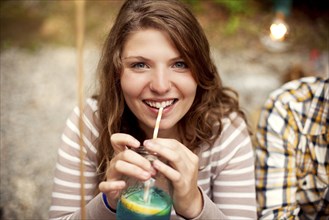 Close up of girl drinking beverage with straw