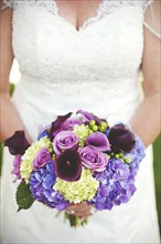 Close up of bride holding wedding bouquet