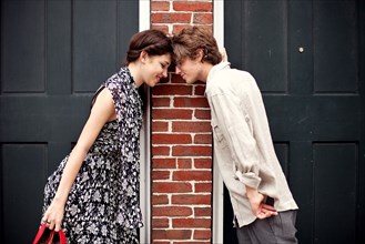 Couple touching foreheads in doorways