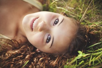 Smiling woman laying in grass