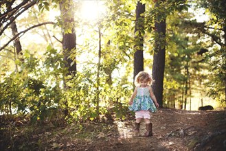 Girl walking on forest path