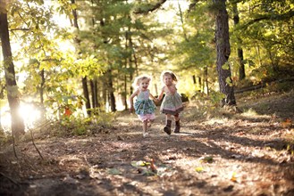 Girls running on forest path