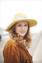 Caucasian teenage girl wearing sun hat outdoors