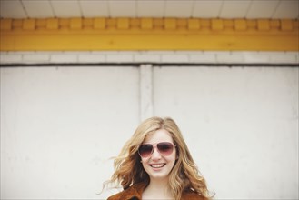Caucasian teenage girl smiling in sunglasses