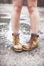 Caucasian woman wearing dirty boots