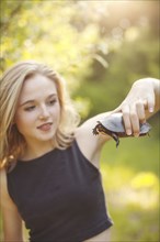 Caucasian woman examining turtle in forest