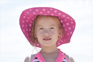 Caucasian girl wearing sun hat under sky