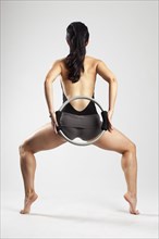 Caucasian woman exercising with resistance ring