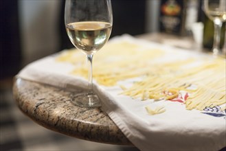 Close up of fresh pasta and glass of white wine