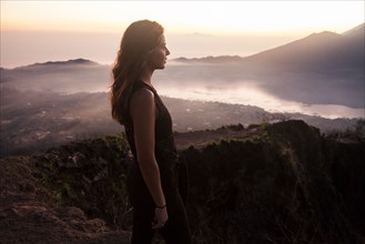 Woman admiring rural landscape from mountaintop