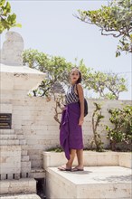 Woman standing on monument in garden