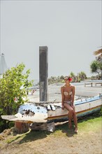 Woman sitting on traditional canoe
