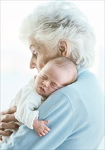 Close up of grandmother holding grandson