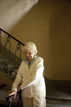 Older Caucasian woman climbing stairs