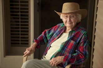 Older Caucasian woman wearing cowboy hat