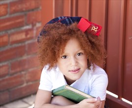 Girl in school uniform holding book