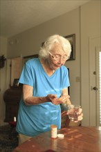 Older Caucasian woman taking medication