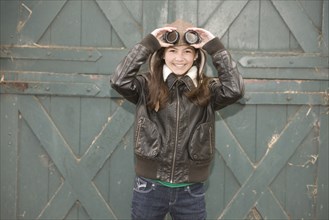 Mixed race girl wearing aviator goggles