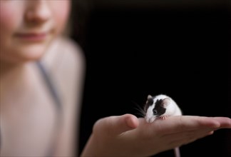 Close up of girl holding pet rat