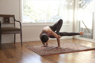 Woman practicing yoga in studio