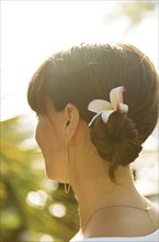 Close up of woman wearing flower in her hair