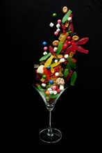Candy falling into cocktail glass