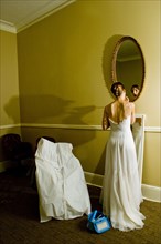 Bride adjusting makeup in mirror