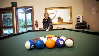 Older Caucasian woman playing pool
