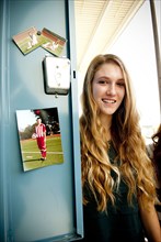 Student standing at decorated locker at high school