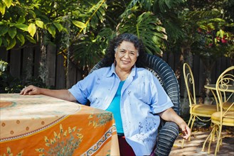 Hispanic woman relaxing in backyard