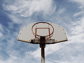 Low angle view of basketball hoop under blue sky