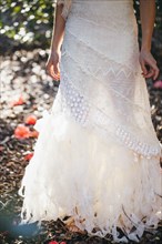 Bride wearing wedding gown in garden