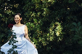 Korean bride wearing wedding dress in garden