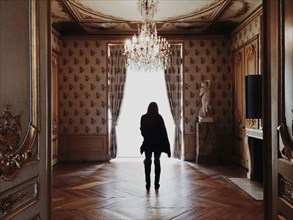 Caucasian woman standing in ornate room
