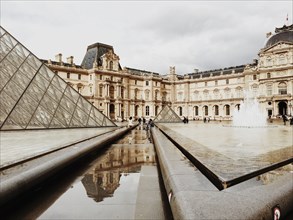 Louvre pyramid and ornate buildings