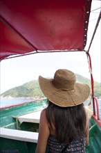 Woman wearing sun hat on ferry boat